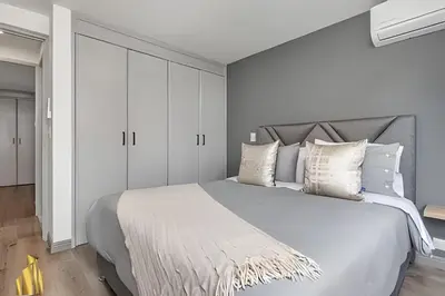a white bedroom with a large bed with white cabinets at Ankara 602 - Private clean & bright Apt with AC in El Poblado
