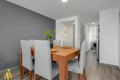 a dining room with a wooden table and white chairs at Ankara 602 - Private clean & bright Apt with AC in El Poblado