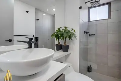 a white bathroom with a sink and a shower at Ankara 602 - Private clean & bright Apt with AC in El Poblado