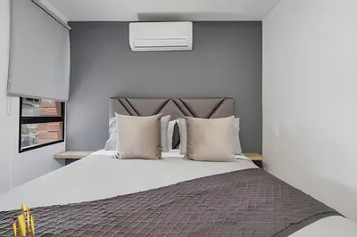 a bedroom with a large bed with white sheets and pillows at Ankara 602 - Private clean & bright Apt with AC in El Poblado