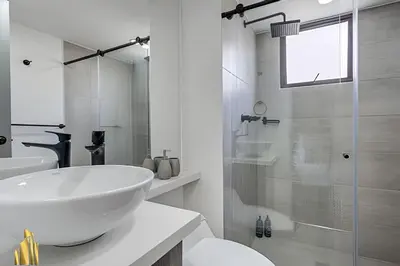 a white bathroom with a sink and a shower at Ankara 602 - Private clean & bright Apt with AC in El Poblado