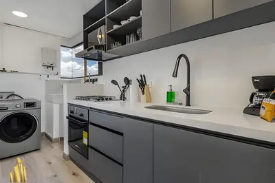 a kitchen with a sink and a washing machine at Ankara 602 - Private clean & bright Apt with AC in El Poblado