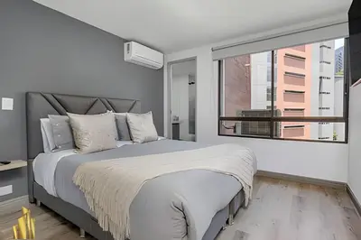 a bedroom with a large bed and a large window at Ankara 602 - Private clean & bright Apt with AC in El Poblado