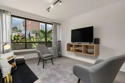 a living room with a flat screen tv on a wall at Ankara 701 - Contemporary clean loft/ Provenza in El Poblado