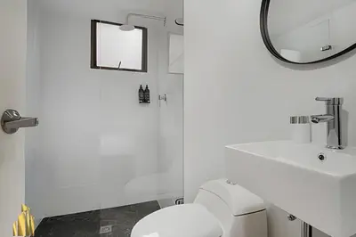 a bathroom with a white toilet and a mirror at Ankara 701 - Contemporary clean loft/ Provenza in El Poblado