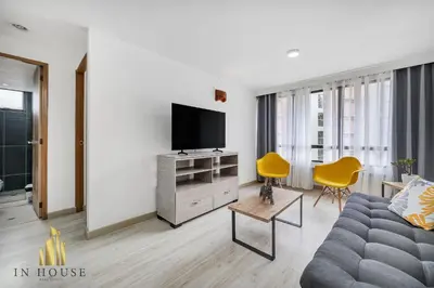 a living room with a couch and a flat screen tv at Ankara 702 - Sophisticated & clean apt in Provenza in El Poblado