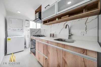 a kitchen with a sink and a white refrigerator at Ankara 702 - Sophisticated & clean apt in Provenza in El Poblado