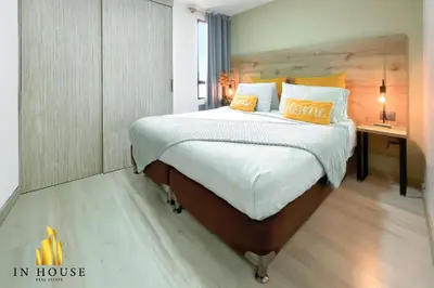 a bedroom with a large bed and a desk at Ankara 702 - Sophisticated & clean apt in Provenza in El Poblado
