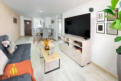 a living room with a blue couch and a tv at Ankara 702 - Sophisticated & clean apt in Provenza in El Poblado
