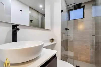 a white bathroom with a sink and a shower at Ankara 802 - Secure & Private apt/ Trendy Provenza in El Poblado