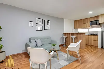 a living room with a couch and a table and chairs at Aria Living 200 - Vibrant Apartment in Laureles in Guayaquil