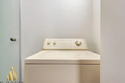 a kitchen with a white stove top oven next to a door at Aria Living 200 - Vibrant Apartment in Laureles in Guayaquil