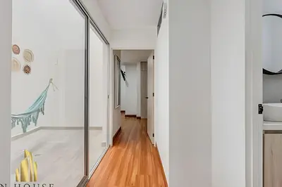 a hallway of a house with a glass door at Aria Living 200 - Vibrant Apartment in Laureles in Guayaquil