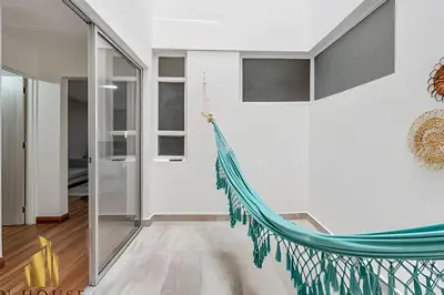 a hammock in the hallway of a house at Aria Living 200 - Vibrant Apartment in Laureles in Guayaquil
