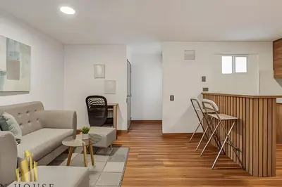 a living room with a couch and a kitchen at Aria Living 201 - Where Design and Location Shine in Guayaquil