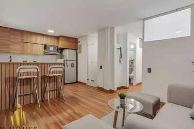 a kitchen and living room with a couch and a table at Aria Living 201 - Where Design and Location Shine in Guayaquil