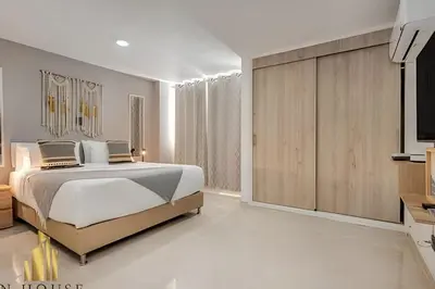 a bedroom with a large bed and a television at Aria Living 202 - Spacious Urban Luxury Retreat in Guayaquil