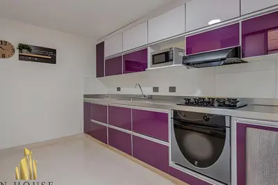 a kitchen with purple cabinets and a sink at Aria Living 202 - Spacious Urban Luxury Retreat in Guayaquil
