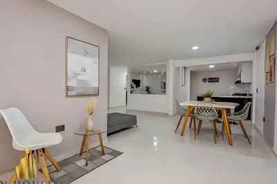 a kitchen and living room with a table and chairs at Aria Living 202 - Spacious Urban Luxury Retreat in Guayaquil