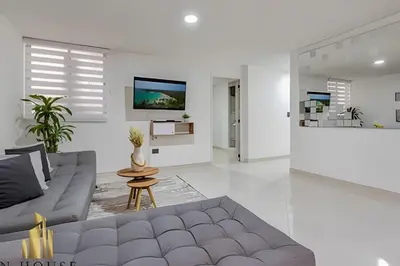 a living room with a couch and a tv at Aria Living 202 - Spacious Urban Luxury Retreat in Guayaquil