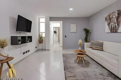 a living room with a couch and a tv at Aria Living 300 - Style and Urban Comfort in Guayaquil