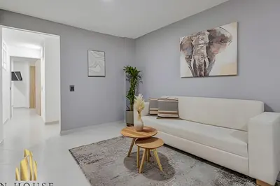 a white living room with a couch and a table at Aria Living 300 - Style and Urban Comfort in Guayaquil