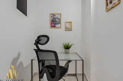 a black chair sitting next to a glass table at Aria Living 300 - Style and Urban Comfort in Guayaquil
