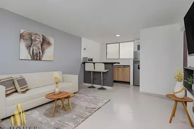 a white living room with a couch and a table at Aria Living 300 - Style and Urban Comfort in Guayaquil