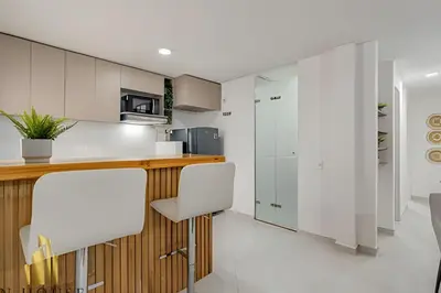 a kitchen with white cabinets and white appliances at Aria Living 301 - Total Exclusivity in Laureles in Guayaquil