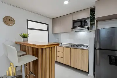a kitchen with a wooden counter and a refrigerator at Aria Living 301 - Total Exclusivity in Laureles in Guayaquil