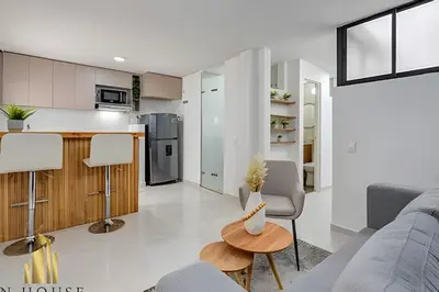 a kitchen and living room with a couch and a table at Aria Living 301 - Total Exclusivity in Laureles in Guayaquil