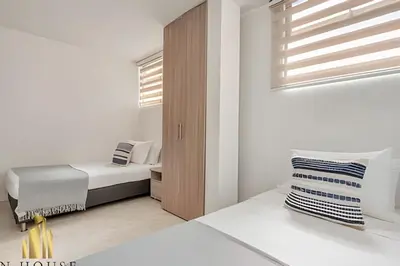 a small bedroom with a bed and a window at Aria Living 302 - Modern and central in Laureles in Guayaquil