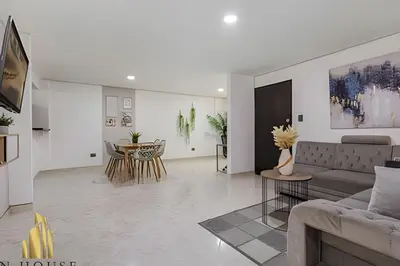 a living room with a couch and a table at Aria Living 302 - Modern and central in Laureles in Guayaquil