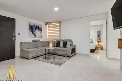 a living room with a couch and a table at Aria Living 302 - Modern and central in Laureles in Guayaquil