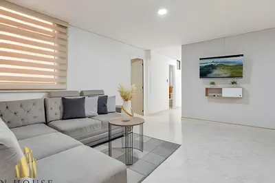 a living room with a couch and a table at Aria Living 302 - Modern and central in Laureles in Guayaquil