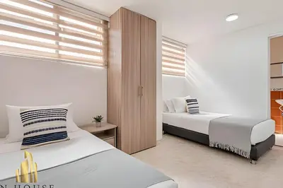 a bedroom with two beds and a window at Aria Living 302 - Modern and central in Laureles in Guayaquil