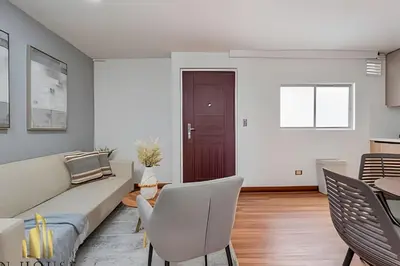 a living room with a couch and chairs and a table at Aria Living 401 - Sophisticated Living in Laureles in Guayaquil