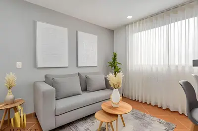 a living room with a couch and a table at Aria Living 500 - Modern with Private Terrace in Guayaquil