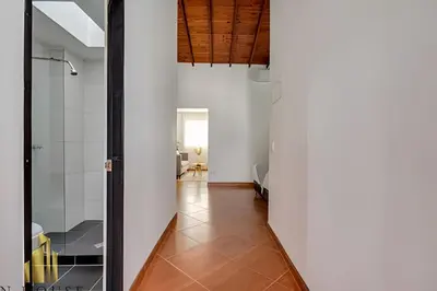 a hallway with white walls and a glass door at Aria Living 500 - Modern with Private Terrace in Guayaquil