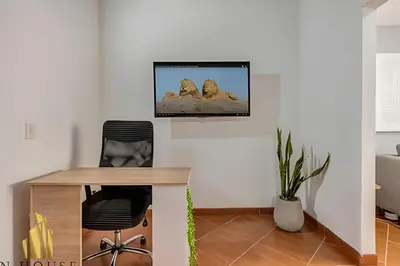 a living room with a tv on the wall at Aria Living 500 - Modern with Private Terrace in Guayaquil