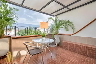 a patio with a table and chairs on a balcony at Aria Living 500 - Modern with Private Terrace in Guayaquil