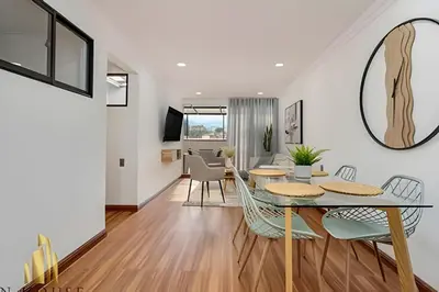 a dining room and living room with a table and chairs at Aria Living 502 - Luxury Terrace in Laureles in Guayaquil
