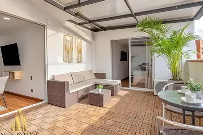 a living room with a couch and a table at Aria Living 502 - Luxury Terrace in Laureles in Guayaquil