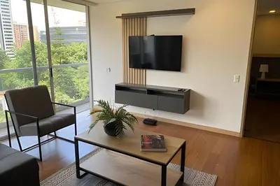 a living room with a flat screen tv on a wall at Campestre 605 - Cozy Studio with AC and Balcony in Envigado