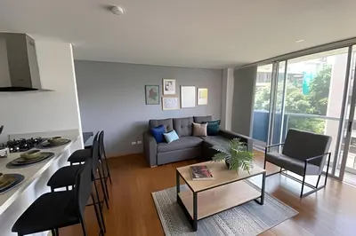 a living room with a couch and a table at Campestre 605 - Cozy Studio with AC and Balcony in Envigado