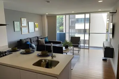 a kitchen and living room with a couch and a sink at Campestre 605 - Cozy Studio with AC and Balcony in Envigado