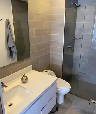 a bathroom with a toilet and a glass shower at Campestre 605 - Cozy Studio with AC and Balcony in Envigado