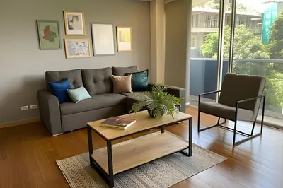 a living room with a couch and a coffee table at Campestre 605 - Cozy Studio with AC and Balcony in Envigado