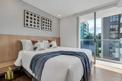 a bedroom with a large bed and a large window at Campestre 704 - Sophisticated Apt with AC & gym in Envigado