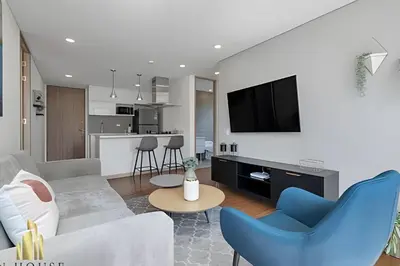 a living room with a couch and a tv at Campestre 704 - Sophisticated Apt with AC & gym in Envigado